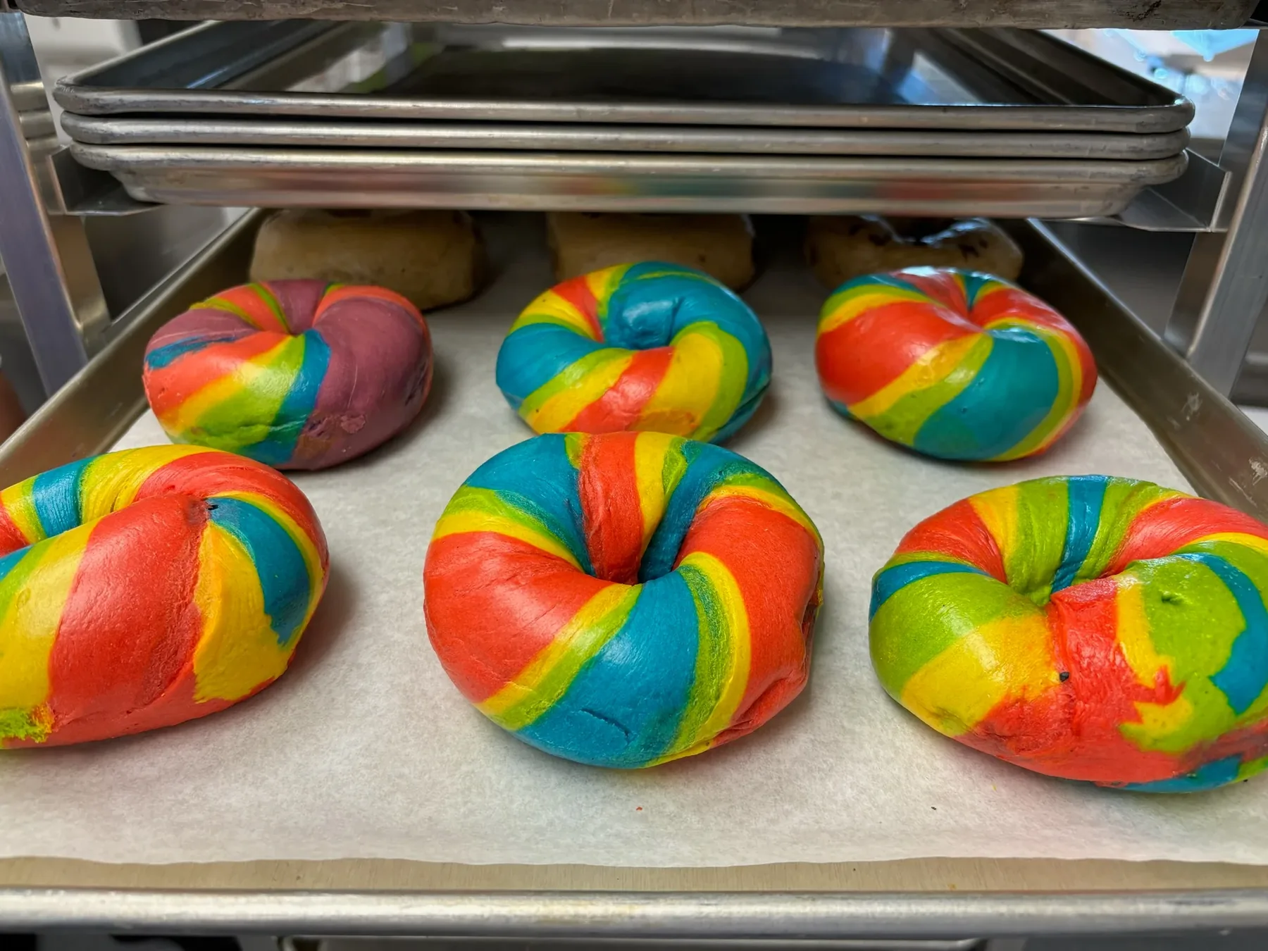 Colorful rainbow tie-dye bagels fresh from the kitchen at B's Bagels
